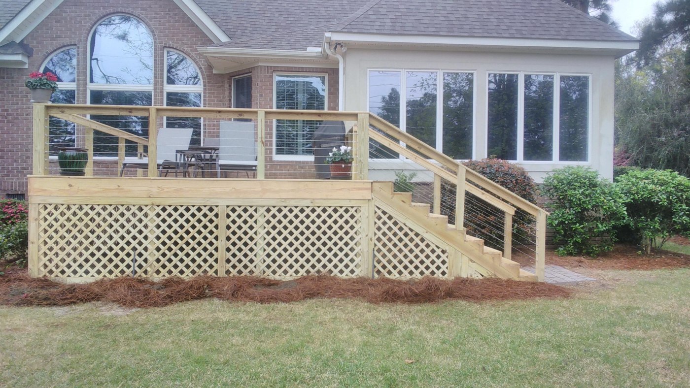 Raised deck with railings, stairs, and lattice skirting
