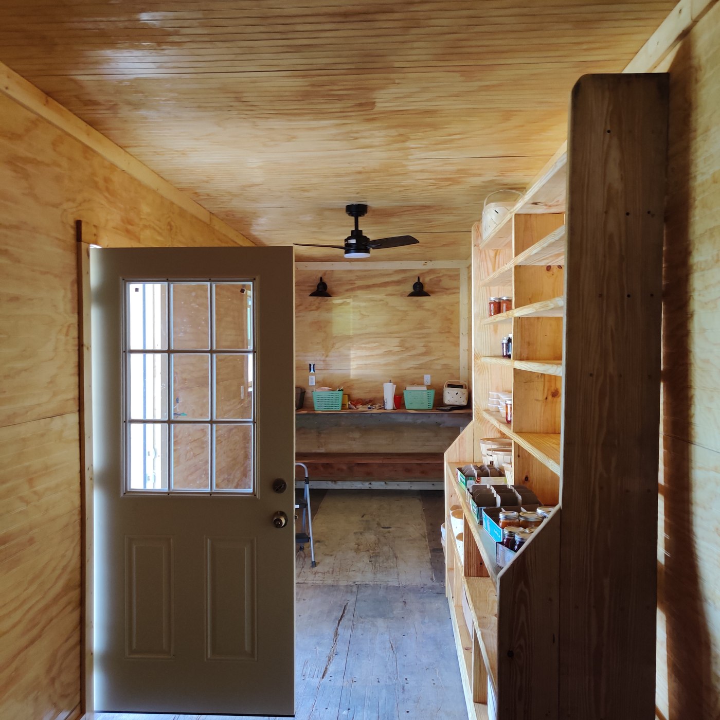 Container renovation with wood-lined interior and shelving