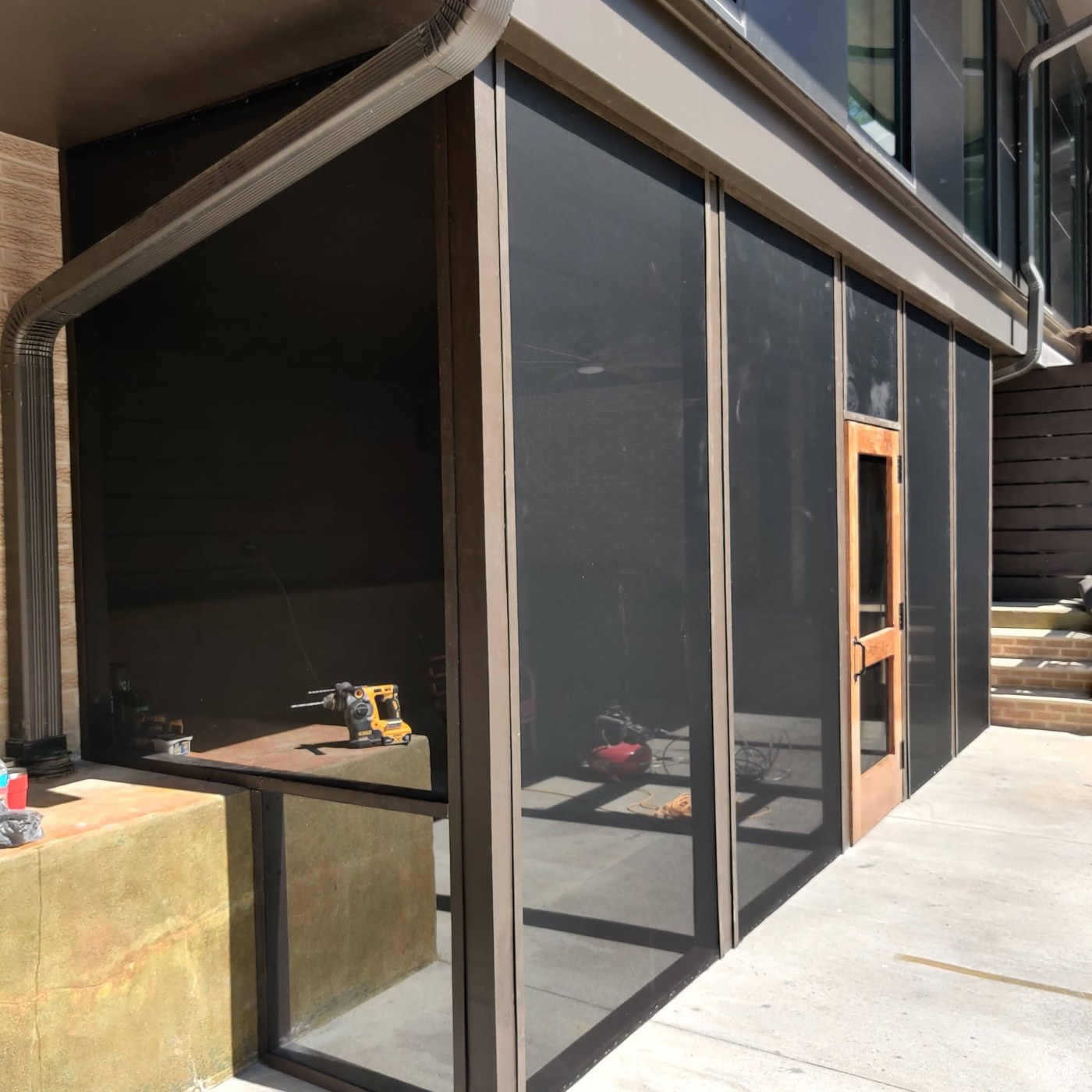 Screened porch exterior with timber door